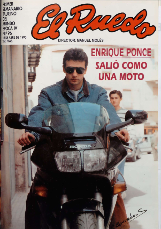 Ein Magazin-Cover mit einem Mann in einer blauen Jacke und Schutzbrille, der ein Motorrad fährt, mit anderen Menschen und Fahrzeugen im Hintergrund.