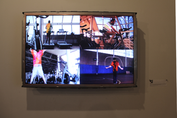 Ein an der Wand befestigter Fernseher mit Übenden.